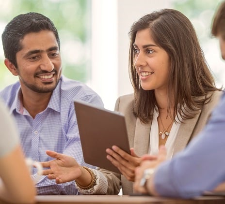 Two people talking with a tablet computer